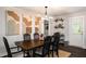 Formal dining room with stylish chandelier, black chairs and art decor at 117 Franklin Rd, Woodstock, GA 30188