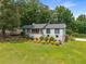 Inviting ranch-style home with lush greenery and a well-maintained lawn at 117 Franklin Rd, Woodstock, GA 30188