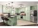 Charming kitchen with light green cabinets, stainless appliances and tile backsplash at 117 Franklin Rd, Woodstock, GA 30188