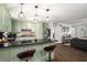 Kitchen with light green cabinets, stainless appliances, bar seating at 117 Franklin Rd, Woodstock, GA 30188