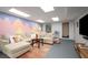 Finished basement living room features a sectional sofa and colorful painted accent wall at 117 Franklin Rd, Woodstock, GA 30188