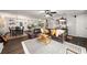Open concept living room with a leather sofa, dining table and view of kitchen at 117 Franklin Rd, Woodstock, GA 30188