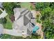Aerial shot of a house, revealing a stunning backyard with a pool, spa, firepit area, and beautiful landscaping at 4105 Cougar Ne Pt, Marietta, GA 30066