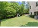 Expansive backyard featuring lush lawn, mature trees, and play set at 4105 Cougar Ne Pt, Marietta, GA 30066