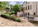 Landscaped backyard of brick home with stone steps and seating at 4105 Cougar Ne Pt, Marietta, GA 30066
