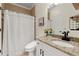 Bathroom featuring modern fixtures, granite counters, and a shower-tub with white shower curtain at 4105 Cougar Ne Pt, Marietta, GA 30066