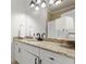 Bathroom featuring granite counters, white cabinetry, and modern fixtures that provide a clean, timeless appeal at 4105 Cougar Ne Pt, Marietta, GA 30066