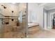Spa-like bathroom with tiled walk-in shower, separate soaking tub, and neutral color scheme at 4105 Cougar Ne Pt, Marietta, GA 30066