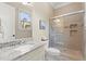 Bathroom with granite countertops, tiled shower with glass door, and tile flooring at 4105 Cougar Ne Pt, Marietta, GA 30066