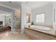 Serene bathroom with walk-in shower, standalone tub, tile floors and access to bedroom at 4105 Cougar Ne Pt, Marietta, GA 30066