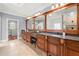 Lavish bathroom with dual vanities, granite countertops, and tiled flooring; view of walk-in shower at 4105 Cougar Ne Pt, Marietta, GA 30066