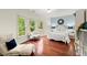 A stylish bedroom with a large window, beautiful hardwood floors, a designer bed and reading space at 4105 Cougar Ne Pt, Marietta, GA 30066