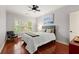 Well-lit bedroom with hardwood floors, a comfortable bed, a ceiling fan and serene ambiance for relaxation at 4105 Cougar Ne Pt, Marietta, GA 30066