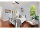 Bedroom with hardwood floors, and light blue walls, and two windows for ample light at 4105 Cougar Ne Pt, Marietta, GA 30066