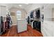 Organized walk-in closet with custom shelving, drawers, and hardwood floors at 4105 Cougar Ne Pt, Marietta, GA 30066