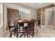 Inviting dining area with brick accent wall, stylish table, and convenient access to stairway at 4105 Cougar Ne Pt, Marietta, GA 30066