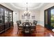 Elegant dining room with hardwood floors, a decorative chandelier and plenty of natural light from the double glass doors at 4105 Cougar Ne Pt, Marietta, GA 30066