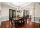 Bright dining room featuring wood floors, decorative chandelier and an arched doorway to another room at 4105 Cougar Ne Pt, Marietta, GA 30066