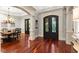 Formal dining room is viewed from the foyer featuring hardwood floors, custom millwork, and arched entryways, filled with natural light at 4105 Cougar Ne Pt, Marietta, GA 30066