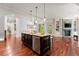 Open kitchen with a large island, hardwood floors, and connection to the living space at 4105 Cougar Ne Pt, Marietta, GA 30066