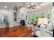 Open concept living room featuring hardwood floors, large windows with backyard views and a fireplace at 4105 Cougar Ne Pt, Marietta, GA 30066