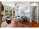 Comfortable living room featuring hardwood floors, large windows, and serene backyard views at 4105 Cougar Ne Pt, Marietta, GA 30066