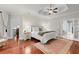 Bright main bedroom with tray ceilings, hardwood floors, a comfortable seating area, and ensuite access at 4105 Cougar Ne Pt, Marietta, GA 30066