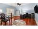 Spacious office features a ceiling fan, hardwood floors, blue walls, and ample workspace with natural light at 4105 Cougar Ne Pt, Marietta, GA 30066