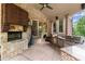 Outdoor kitchen and stone fireplace with barstool seating area at 4105 Cougar Ne Pt, Marietta, GA 30066