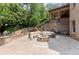Charming outdoor patio with stone fireplace, comfortable seating, and access to lush garden at 4105 Cougar Ne Pt, Marietta, GA 30066