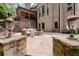 Inviting outdoor patio with stone fireplace, comfortable seating, and manicured landscaping at 4105 Cougar Ne Pt, Marietta, GA 30066