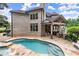 Pool and spa with covered outdoor kitchen and landscaping at 4105 Cougar Ne Pt, Marietta, GA 30066