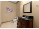 Elegant powder room with ornate vanity, black countertop, decorative mirror and neutral decor at 4105 Cougar Ne Pt, Marietta, GA 30066