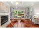 Comfortable sitting room with fireplace, hardwood floors, and large window; fireplace and neutral color scheme at 4105 Cougar Ne Pt, Marietta, GA 30066