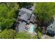 Aerial view of home with pool, patio, and surrounding mature trees offering privacy at 1011 W Paces Ferry Nw Rd, Atlanta, GA 30327