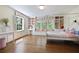 Spacious bedroom with built-in shelving and window seat, featuring hardwood floors and a four-poster bed at 1011 W Paces Ferry Nw Rd, Atlanta, GA 30327