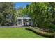 Stately home featuring a large front lawn, mature trees, and a columned front porch at 1011 W Paces Ferry Nw Rd, Atlanta, GA 30327