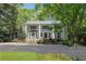 Traditional two-story home featuring a front porch with white columns and a well-manicured lawn at 1011 W Paces Ferry Nw Rd, Atlanta, GA 30327