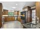 Traditional-style kitchen featuring wood cabinetry, stainless steel appliances, and granite countertops at 1011 W Paces Ferry Nw Rd, Atlanta, GA 30327