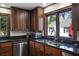 Close-up of kitchen with dark wood cabinets, granite countertops, and stainless steel appliances at 1011 W Paces Ferry Nw Rd, Atlanta, GA 30327