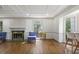 Cozy living room featuring a fireplace, hardwood floors, and large windows that let in natural light at 1011 W Paces Ferry Nw Rd, Atlanta, GA 30327