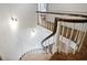 Elegant curved staircase with carpeted steps and wood railing at 1011 W Paces Ferry Nw Rd, Atlanta, GA 30327