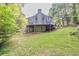 The large backyard features a spacious deck and patio, perfect for outdoor living and entertaining amidst lush greenery at 1253 Rivermark Ct, Lawrenceville, GA 30043