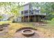 An outdoor fire pit and wooden deck elevate this home's backyard at 1253 Rivermark Ct, Lawrenceville, GA 30043