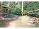 The landscaped yard features brick-lined garden beds, brick columns and a tree filled backdrop at 1253 Rivermark Ct, Lawrenceville, GA 30043