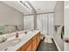 Functional bathroom featuring a double sink vanity and shower tub with curtain at 1253 Rivermark Ct, Lawrenceville, GA 30043