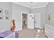 Light-filled bedroom showcasing neutral walls and a glimpse into the hallway at 1253 Rivermark Ct, Lawrenceville, GA 30043