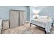 Cozy bedroom featuring neutral walls, wood floors, and essential furniture at 1253 Rivermark Ct, Lawrenceville, GA 30043