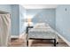 Bright bedroom with modern finishes including wood-look floors and neutral walls at 1253 Rivermark Ct, Lawrenceville, GA 30043
