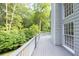 A large, wooden deck provides an outdoor space with forest views for enjoying the beauty of nature at 1253 Rivermark Ct, Lawrenceville, GA 30043